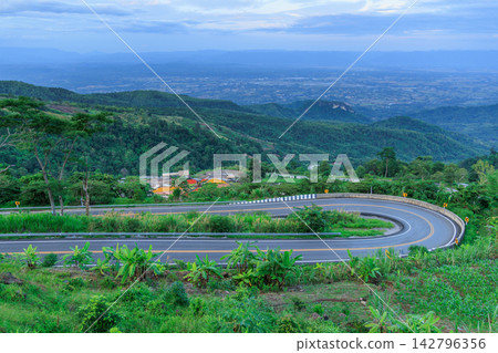 Winding downhill road at Thailand, photographed from the driver's perspective while driving. Winding downhill road at Thailand, photographed from the driver's perspective while driving. 142796356