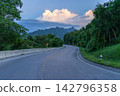 Winding downhill road at Thailand, photographed from the driver's perspective while driving. 142796358
