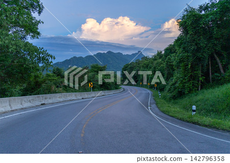 Winding downhill road at Thailand, photographed from the driver's perspective while driving. Winding downhill road at Thailand, photographed from the driver's perspective while driving. 142796358