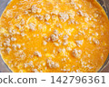 Fresh and appetizing Thai-style omelet cooking in a frying pan. 142796361