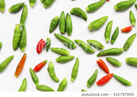 Fresh bird's eye chilies on white background. 142797009
