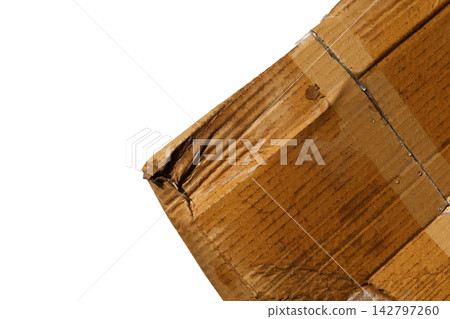 A heavily damaged, wet, and torn brown corrugated cardboard box. A heavily damaged, wet, and torn brown corrugated cardboard box. 142797260