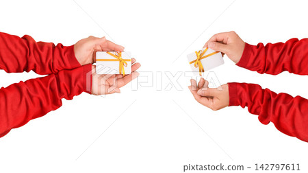 Female hands in red sleeves present a gift card isolated on white background with copy space for online shopping bonuses promotions discounts Christmas gifts and retail offers 142797611