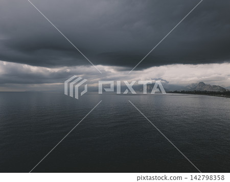 Dramatic sky and peaceful sea at sunrise 142798358