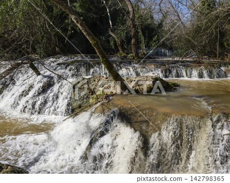 Majestic waterfall cascade in wilderness 142798365