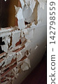 A photo of a shoji screen in a Japanese-style room, severely torn by a cat's claws, exposing the latticework. A photo of a shoji screen in a Japanese-style room, severely torn by a cat's claws, exposing the latticework. 142798559