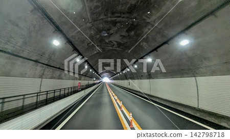 The road inside the tunnel leads straight to the exit. The road inside the tunnel leads straight to the exit. 142798718