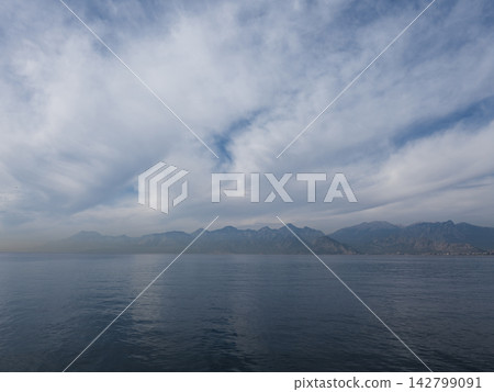 Calm sea under approaching storm clouds Calm sea under approaching storm clouds 142799091