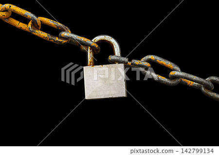 Old metal chain with peeling orange paint, connected by hanging steel padlock, isolated on black background with clipped path, empty copy space. Symbol of closed access end of free path. Artwork blank Old metal chain with peeling orange paint, connected by hanging steel padlock, isolated on black background with clipped path, empty copy space. Symbol of closed access end of free path. Artwork blank 142799134