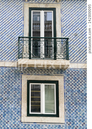 Beautiful tile designs on buildings in Lisbon with balconies and windows Beautiful tile designs on buildings in Lisbon with balconies and windows 142800095