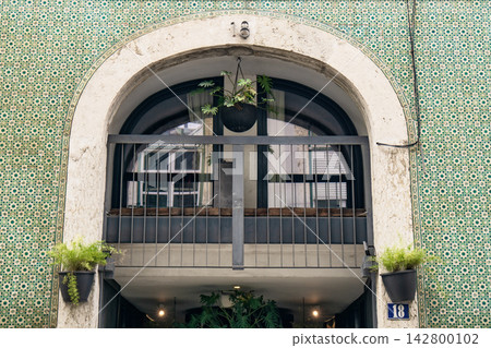 Balcony view of a building in Lisbon with green tiles and plants Balcony view of a building in Lisbon with green tiles and plants 142800102