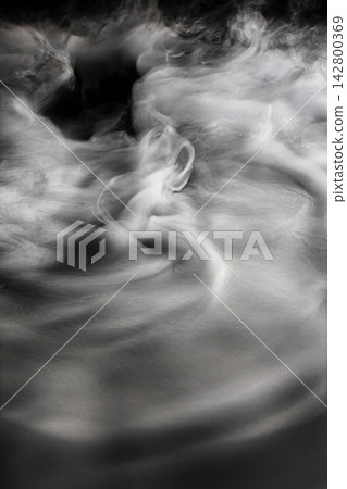 Dry ice smoke and fog spread across a black background. Dry ice smoke and fog spread across a black background. 142800369