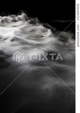 Dry ice smoke and fog spread across a black background. Dry ice smoke and fog spread across a black background. 142800408