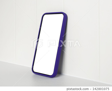 Phone mockup with a blank white screen leans against a light kitchen backsplash tile wall. Template Phone mockup with a blank white screen leans against a light kitchen backsplash tile wall. Template 142801075