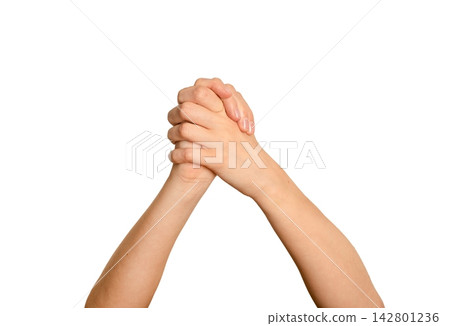 Two arms crossed with hands clasped in a support gesture. Woman s fingers interlocked forming a bond Two arms crossed with hands clasped in a support gesture. Woman s fingers interlocked forming a bond 142801236