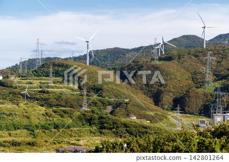Wind turbines and power transmission towers stand in the hilly region of the Tsugaru Peninsula. Wind turbines and power transmission towers stand in the hilly region of the Tsugaru Peninsula. 142801264