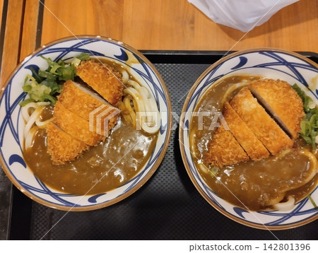 Two Bowls of Japanese Chicken Katsu Curry Udon Noodles with Crispy Fried Cutlet on Tray 142801396