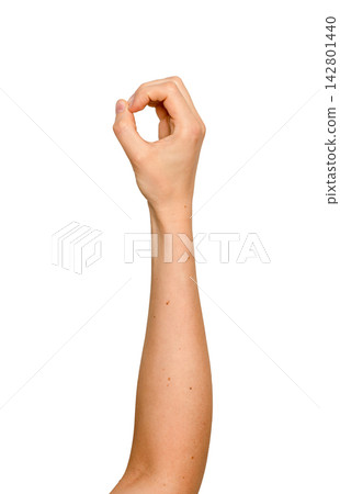 Woman s fingers forming a circular grip in mid-air. Left arm raised holding an invisible round Woman s fingers forming a circular grip in mid-air. Left arm raised holding an invisible round 142801440