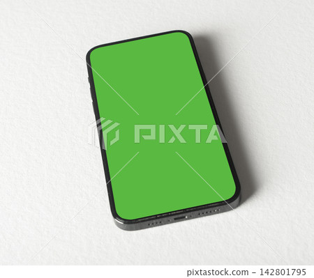 Phone mockup with a bright green chroma key screen stands vertically on a plain grey background. The Phone mockup with a bright green chroma key screen stands vertically on a plain grey background. The 142801795