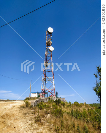 A tall telecommunication tower stands proudly on a sunny grassy hill under a bright blue sky, symbolizing connectivity and technological progress. Ideal for tech themes. Nobody. A tall telecommunication tower stands proudly on a sunny grassy hill under a bright blue sky, symbolizing connectivity and technological progress. Ideal for tech themes. Nobody. 142801956