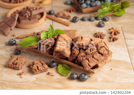 Brownie with fresh blueberries and mint. Brownie with fresh blueberries and mint. 142802204