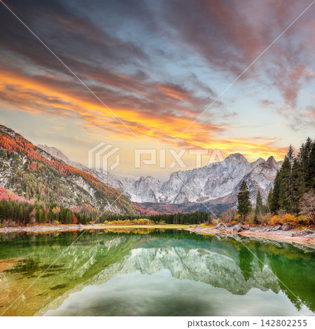 Stunning view of Fusine lake with Mangart peak on background. Stunning view of Fusine lake with Mangart peak on background. 142802255
