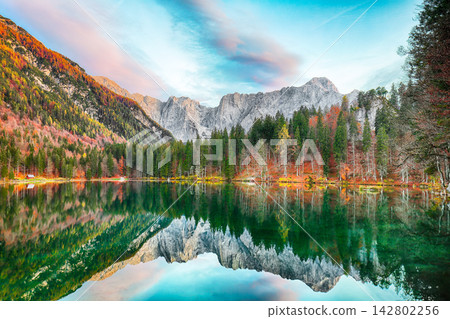 Stunning view of Fusine lake with Mangart peak on background. Stunning view of Fusine lake with Mangart peak on background. 142802256