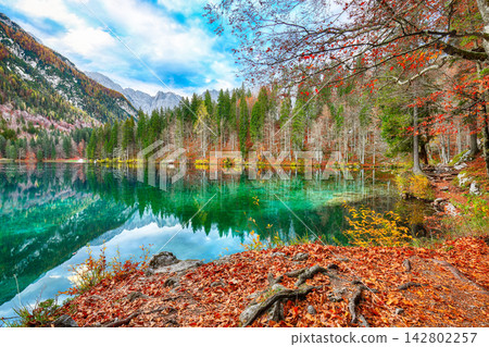 Breathtaking view of Fusine lake with Mangart peak on background. Breathtaking view of Fusine lake with Mangart peak on background. 142802257