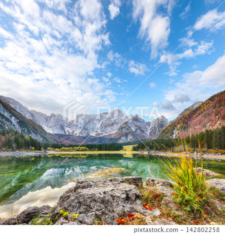 Breathtaking view of Fusine lake with Mangart peak on background. Breathtaking view of Fusine lake with Mangart peak on background. 142802258