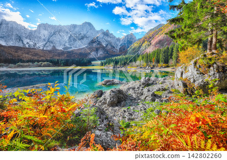 Fabulous view of Fusine lake with Mangart peak on background. Fabulous view of Fusine lake with Mangart peak on background. 142802260