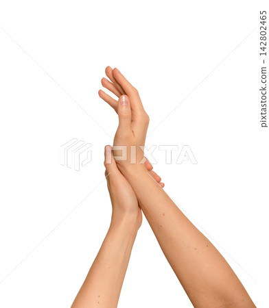 Woman s hands crossing gently in a beauty skincare gesture. Delicate arms touching during a Woman s hands crossing gently in a beauty skincare gesture. Delicate arms touching during a 142802465
