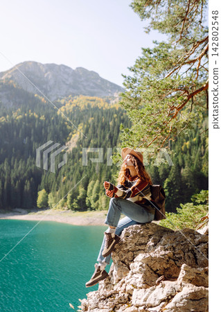 Adventure woman feeling happy among amazing mountains, forest and lake, enjoy the nature landscape Adventure woman feeling happy among amazing mountains, forest and lake, enjoy the nature landscape 142802548
