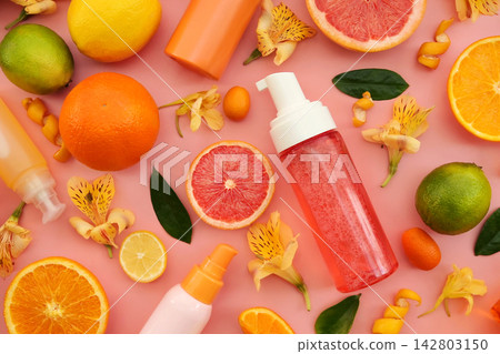 Cosmetic bottles on bright citrus fruits and flowers background, natural scincare cosmetics, beauty and facial care concept image, selective focus, shallow DOF Cosmetic bottles on bright citrus fruits and flowers background, natural scincare cosmetics, beauty and facial care concept image, selective focus, shallow DOF 142803150
