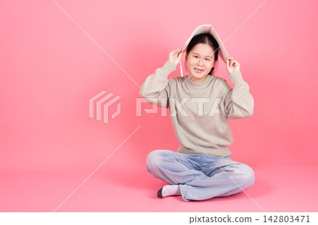 Happy Smiling Cute Lovely Asian Student Girl Sitting with Book College Education Studio Background 142803471