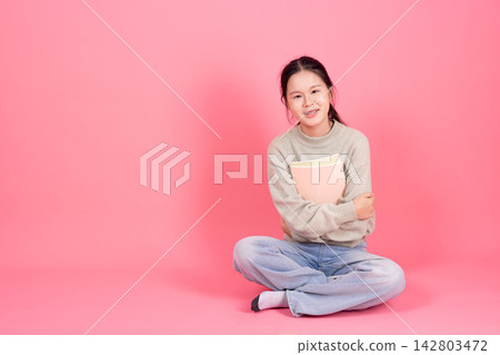 Happy Smiling Cute Lovely Asian Student Girl Sitting with Book College Education Studio Background Happy Smiling Cute Lovely Asian Student Girl Sitting with Book College Education Studio Background 142803472
