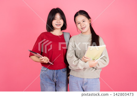 Two Asian Girl Friends Students Standing Together College Education Concept Studio Two Asian Girl Friends Students Standing Together College Education Concept Studio 142803473