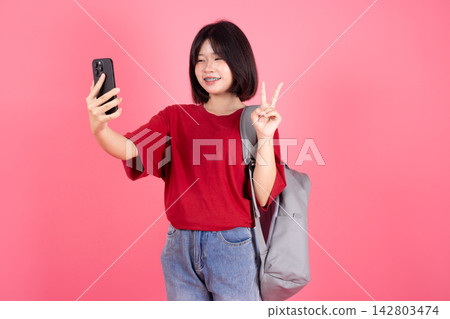 Asian Female Student Taking Selfie Smartphone Selfie Shooting Gesture Pink Background Studio 142803474
