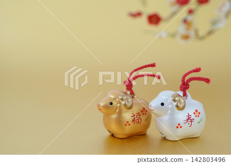 羊年新年卡片素材:金色背景上點綴著可愛的金銀綿羊和梅花。 羊年新年卡片素材:金色背景上點綴著可愛的金銀綿羊和梅花。 142803496