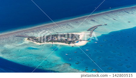 Breathtaking panoramic aerial reef sandbar splitting vivid azure Maldives lagoon deep blue tropical sea wide paradise. Perfect summer travel vacation island getaway. Exotic honeymoon holiday coast Breathtaking panoramic aerial reef sandbar splitting vivid azure Maldives lagoon deep blue tropical sea wide paradise. Perfect summer travel vacation island getaway. Exotic honeymoon holiday coast 142803515
