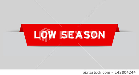 Red color inserted label with word low season on gray background Red color inserted label with word low season on gray background 142804244