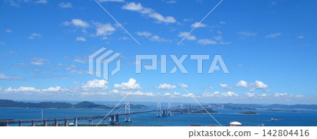 The Seto Ohashi Bridge (a bridge connecting Okayama and Kagawa prefectures) spans the Seto Inland Sea against a backdrop of blue sky. The Seto Ohashi Bridge (a bridge connecting Okayama and Kagawa prefectures) spans the Seto Inland Sea against a backdrop of blue sky. 142804416
