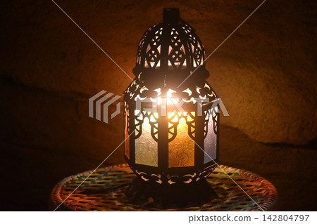 arabian lamp shinning ligh on table in dark night arabian lamp shinning ligh on table in dark night 142804797