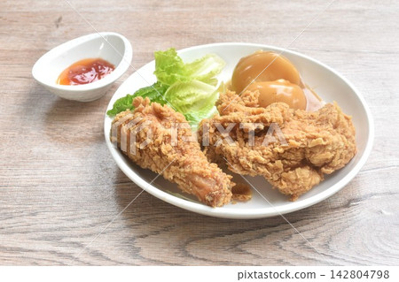 crispy fried chicken and mashed potato dressing gravy sauce with cos lettuce salad on plate dipping ketchup and chili sauce crispy fried chicken and mashed potato dressing gravy sauce with cos lettuce salad on plate dipping ketchup and chili sauce 142804798