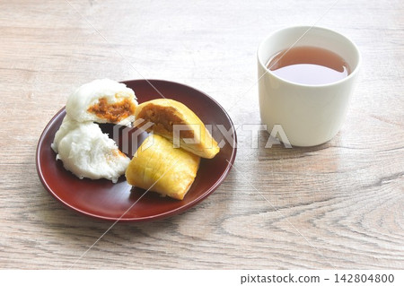 steamed bao Chinese bun stuffing mashed red sweet pork and fried pastry bean on plate eat couple with hot tea steamed bao Chinese bun stuffing mashed red sweet pork and fried pastry bean on plate eat couple with hot tea 142804800