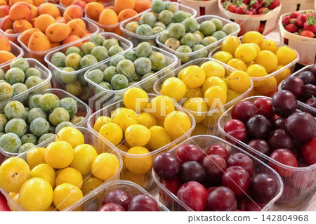Colorful plum varieties displayed in market trays Colorful plum varieties displayed in market trays 142804968
