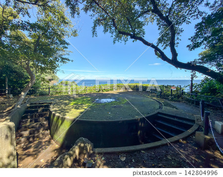 The quiet circular gun battery remains of Sarushima Fortress, overlooking the blue sea and sky. 142804996