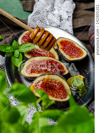 Fresh Figs with Honey and Basil Leaves, Sliced Fig Rustic Food Still Life Fresh Figs with Honey and Basil Leaves, Sliced Fig Rustic Food Still Life 142805201