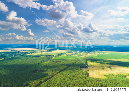 Rural landscape, aerial view. View of plowed and green fields and forest in spring. Rural landscape, aerial view. View of plowed and green fields and forest in spring. 142805255