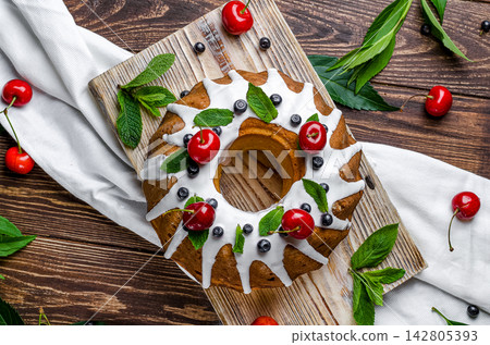 Glazed Bundt Cake with Fresh Fruits and White Icing Glazed Bundt Cake with Fresh Fruits and White Icing 142805393
