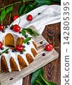 Glazed Bundt Cake with Fresh Fruits and White Icing 142805395
